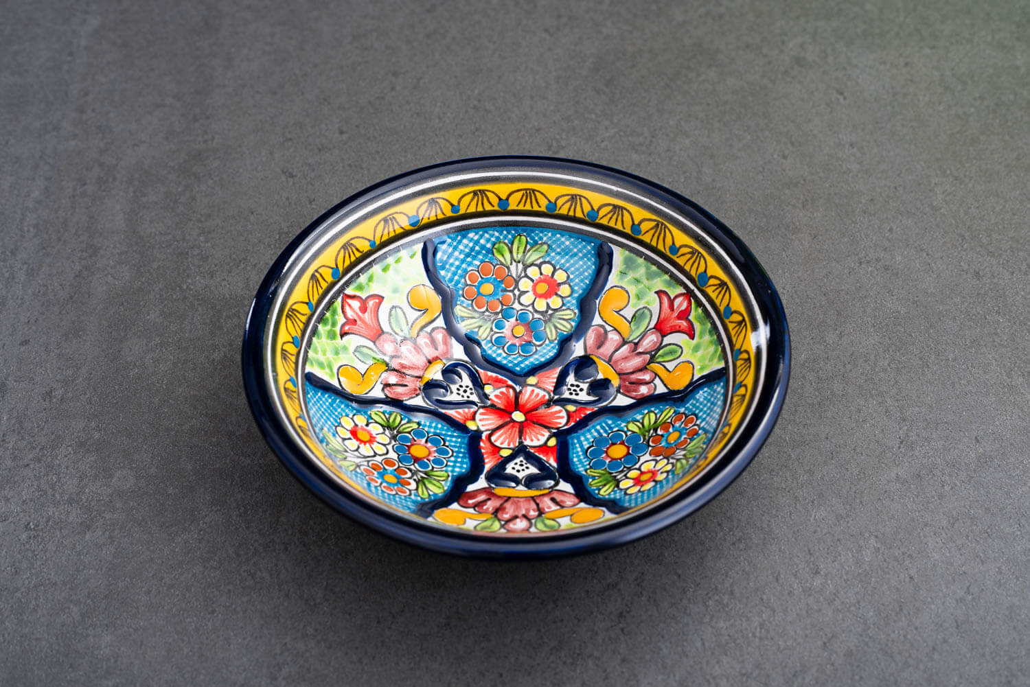 bunter Bowl blau-grün-gelb mit Blumen auf Schieferplatte